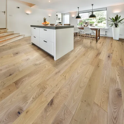 Light engineered wood flooring installed in an open kitchen