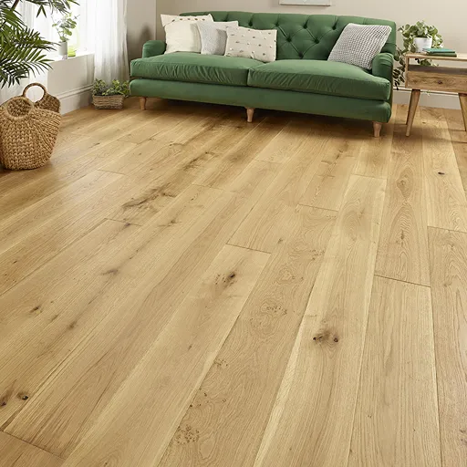 Oak engineered wood flooring in a living area with green sofa